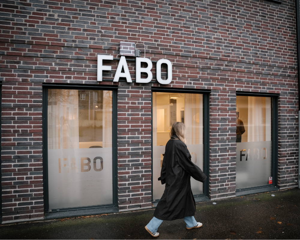Fabos fasad, kvinna går framför
